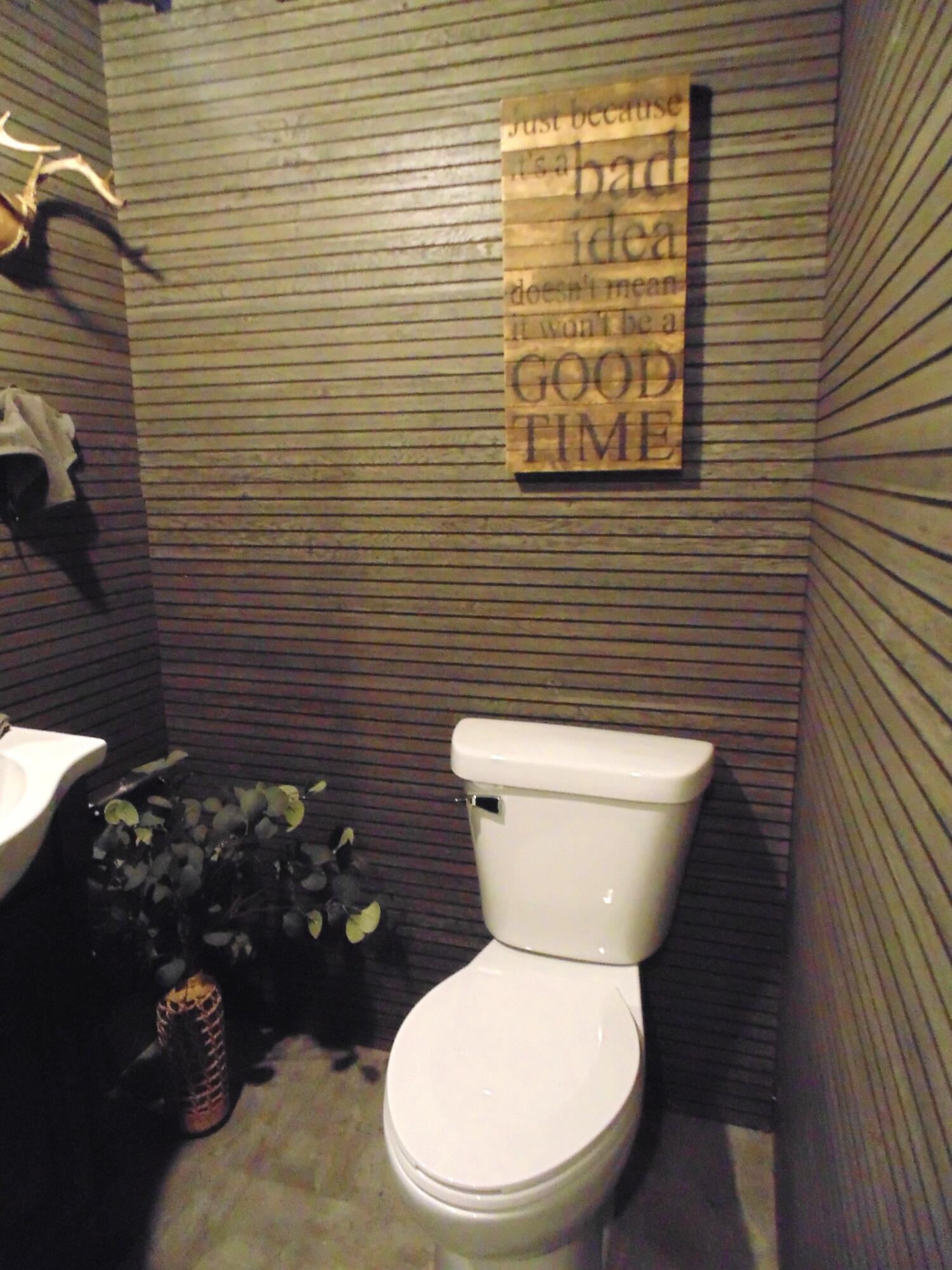 6801 Forest Avenue Gary, IN 46403 - Photo 22 of 23 a white toilet sitting next to a small bathroom sink