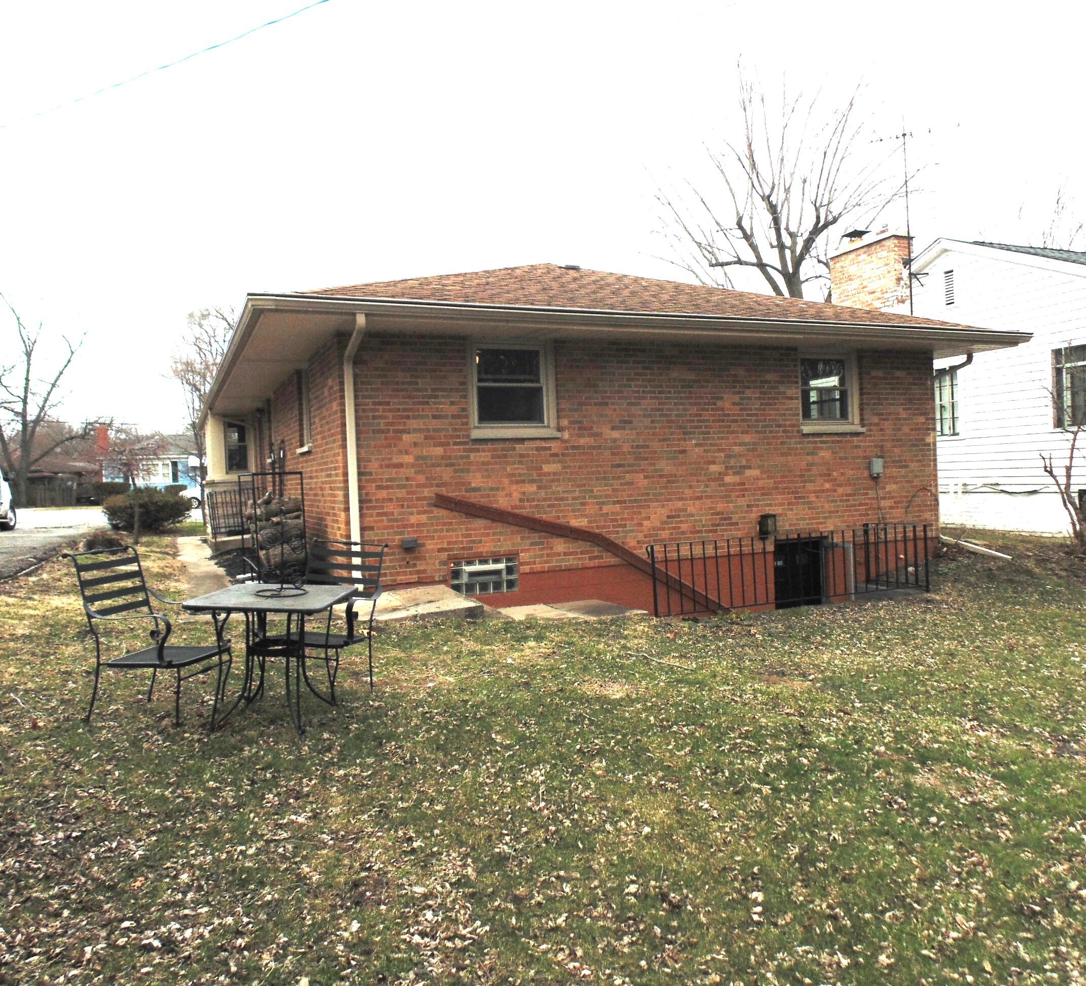 6801 Forest Avenue Gary, IN 46403 - Photo 23 of 23 a brick house with lawn chairs and a table