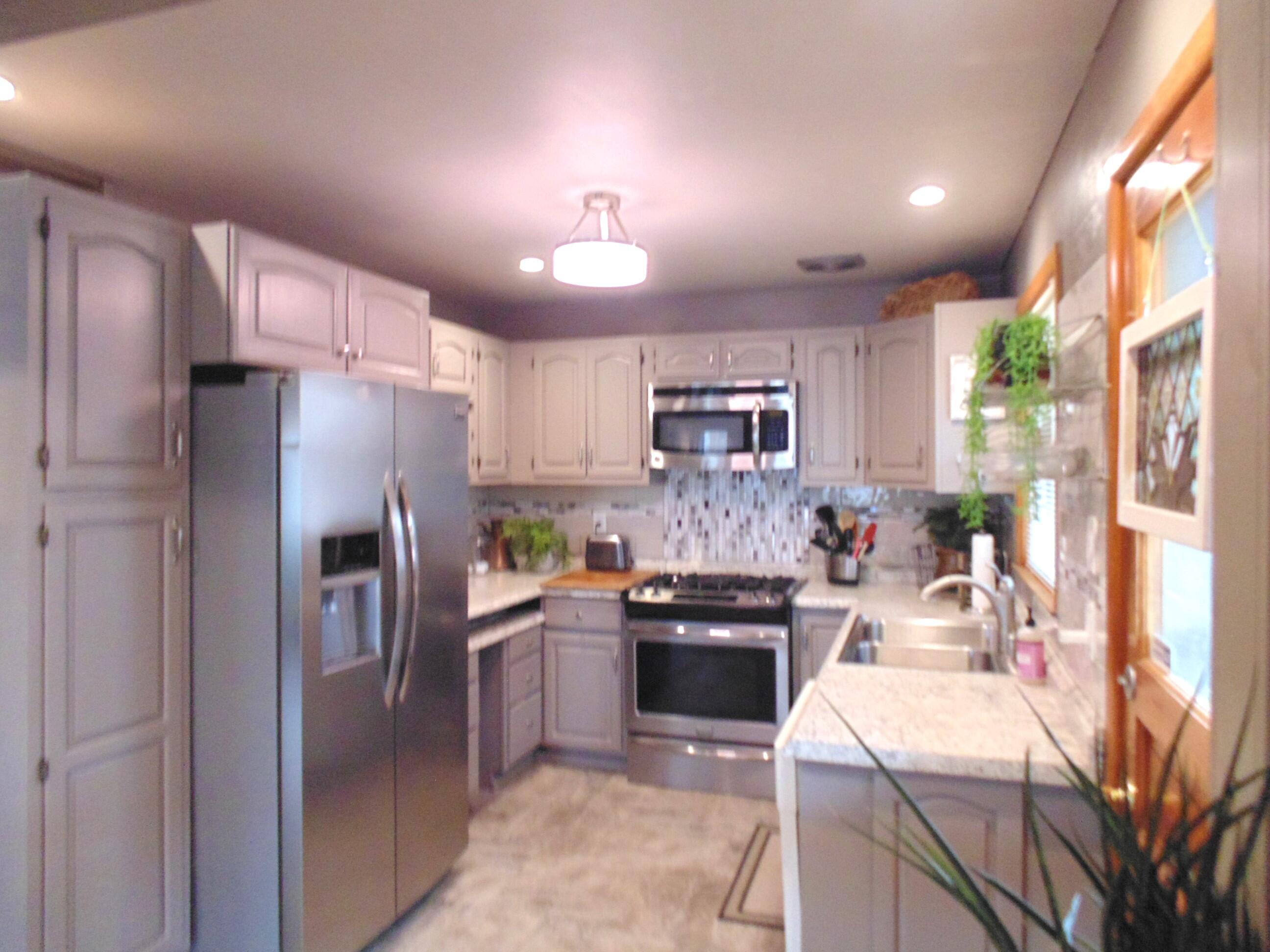 6801 Forest Avenue Gary, IN 46403 - Photo 10 of 23 a kitchen with stainless steel appliances granite countertop a sink stove and refrigerator