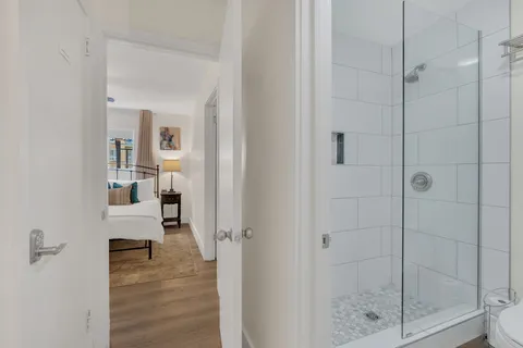 a bathroom with a glass shower door