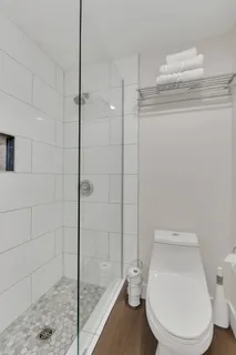 a white toilet sitting next to a bath tub and shower