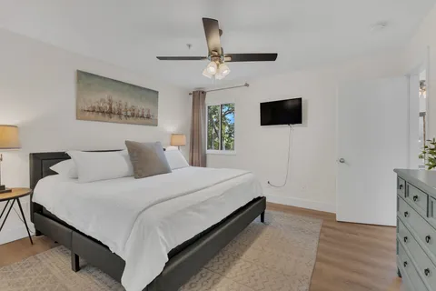 a bedroom with a bed and a flat screen tv