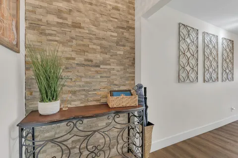a view of a room with a potted plant and wooden floor