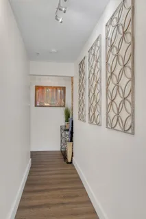 a hallway with wooden floor and table
