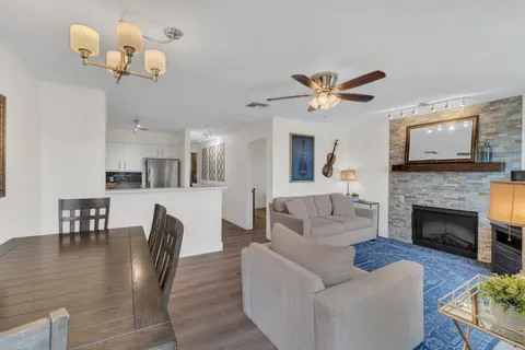 a living room with furniture chandelier and a fireplace