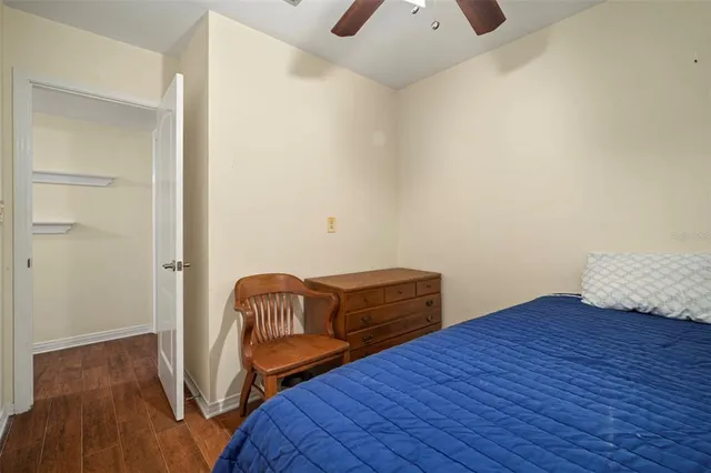 a view of bedroom with a bed and wooden floor