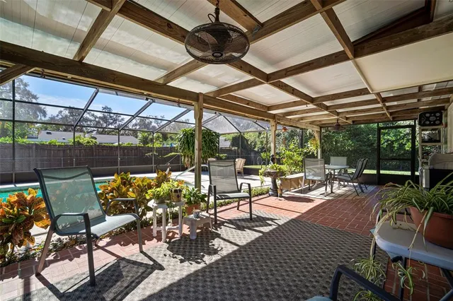 a view of a patio with table and chairs and potted plants