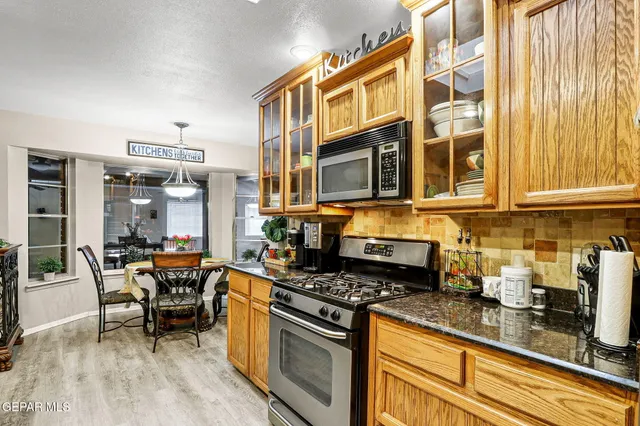 a kitchen with stainless steel appliances granite countertop a stove and a sink