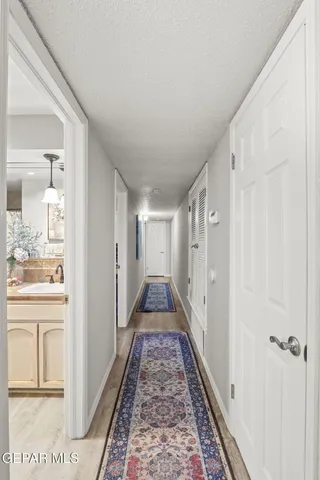 a view of a hallway with a rug and a window