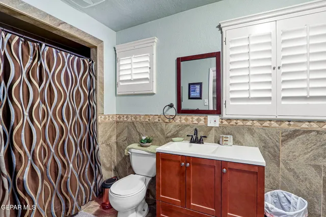 a bathroom with a sink a toilet and a mirror