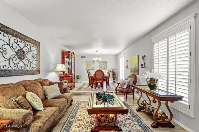 a living room with furniture a window and a flat screen tv