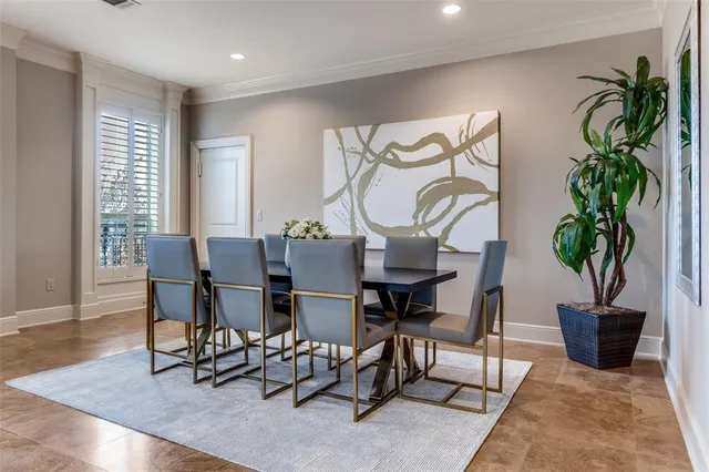 a dining room with furniture potted plants and wooden floor