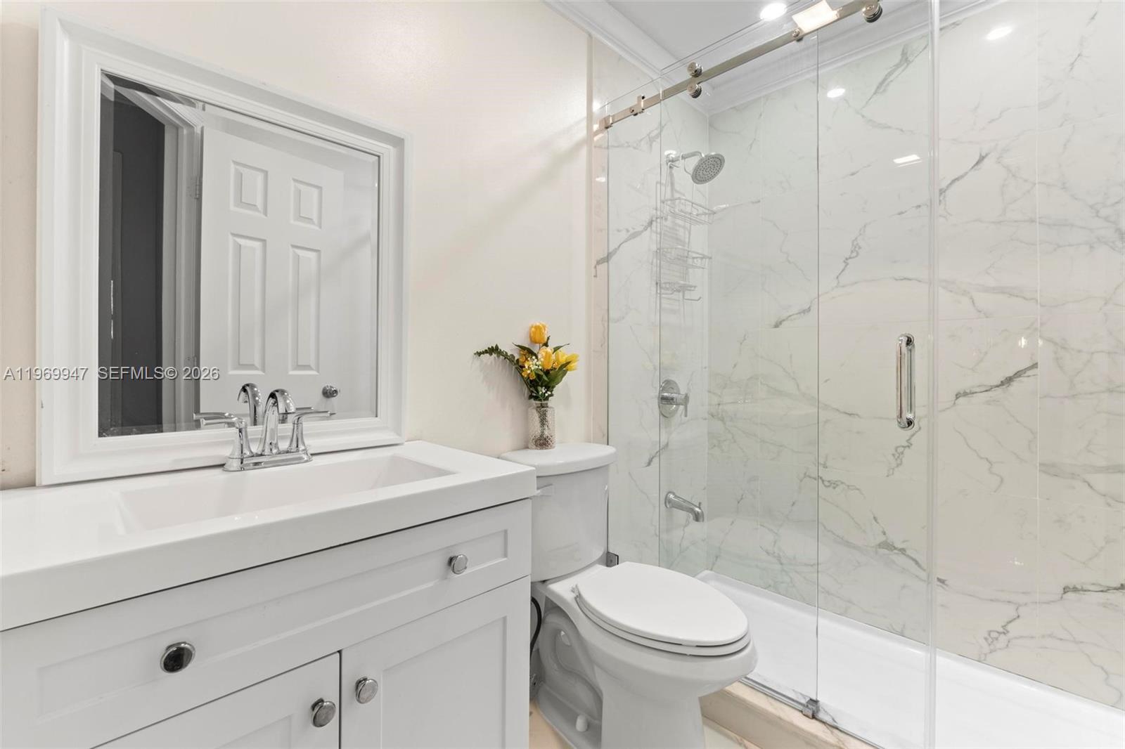 3370 Beau Rivage Drive, Unit B8 Pompano Beach, FL 33064 - Photo 11 of 33 a bathroom with a sink a toilet and shower