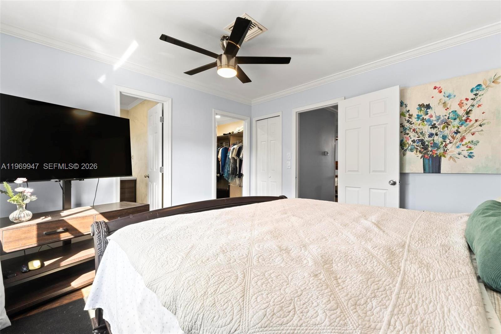 3370 Beau Rivage Drive, Unit B8 Pompano Beach, FL 33064 - Photo 12 of 33 a bedroom with a bed and a flat screen tv