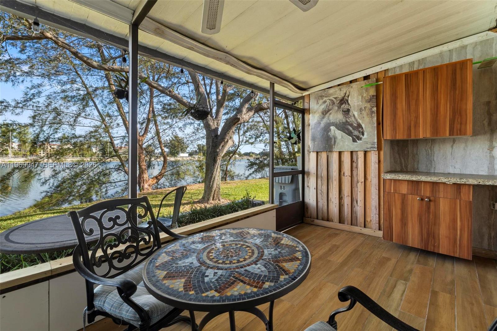 3370 Beau Rivage Drive, Unit B8 Pompano Beach, FL 33064 - Photo 17 of 33 a view of a chairs and table in a room