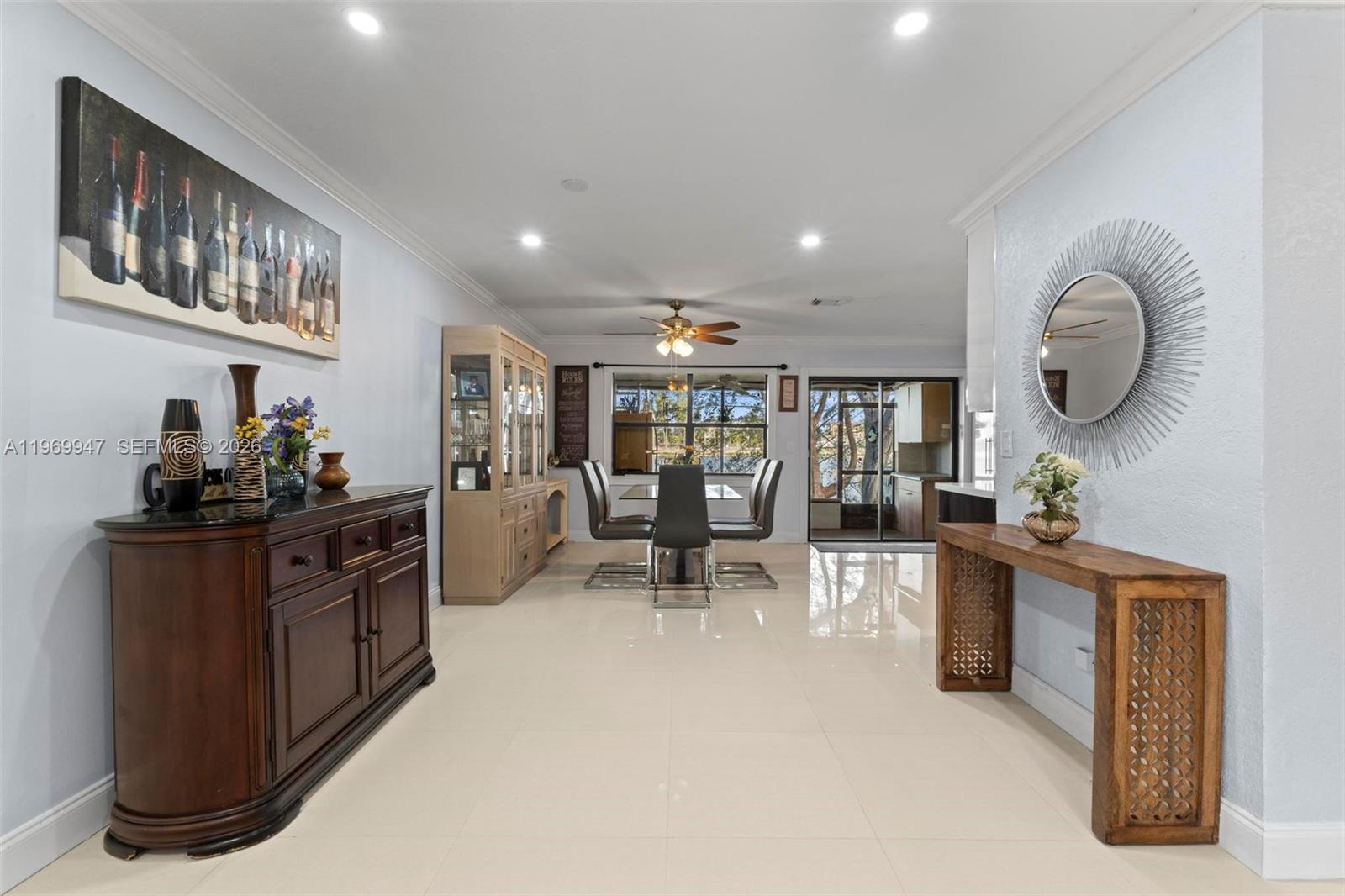 3370 Beau Rivage Drive, Unit B8 Pompano Beach, FL 33064 - Photo 25 of 33 a living room with furniture a clock and wooden floors