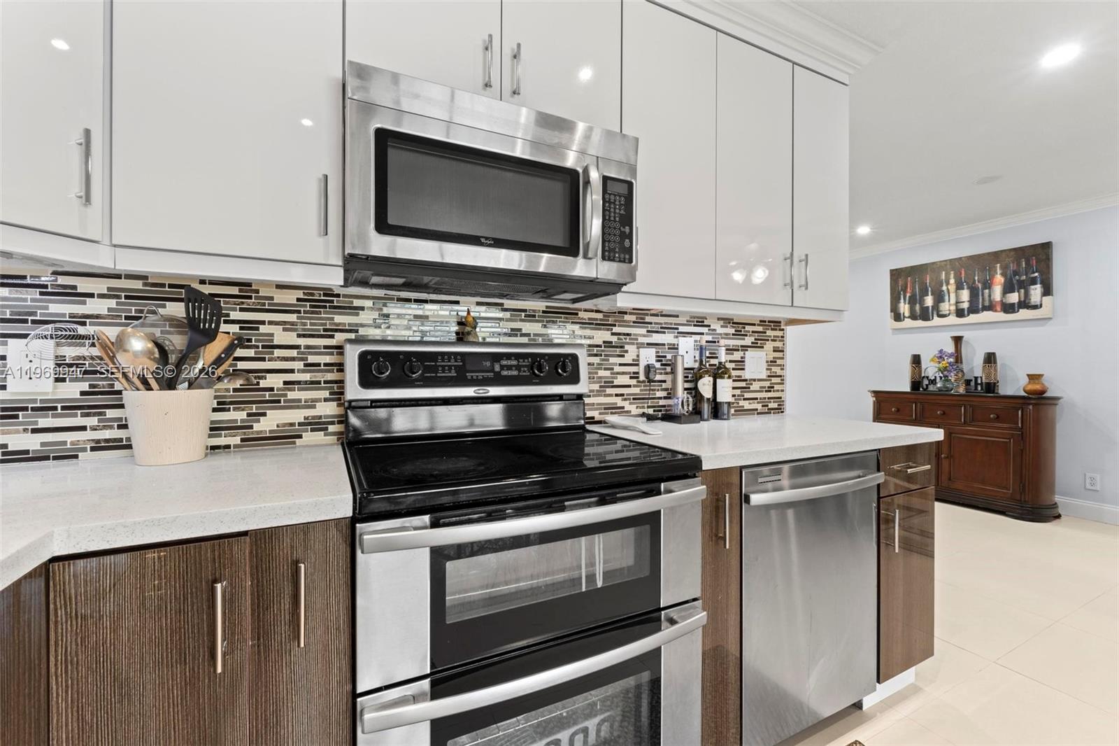 3370 Beau Rivage Drive, Unit B8 Pompano Beach, FL 33064 - Photo 32 of 33 a kitchen with stainless steel appliances a stove a microwave and cabinets