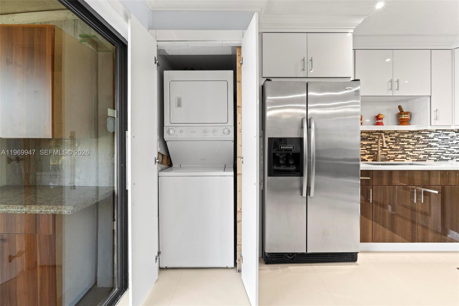 3370 Beau Rivage Drive, Unit B8 Pompano Beach, FL 33064 - Photo 33 of 33 a kitchen with metallic refrigerator freezer and a dishwasher