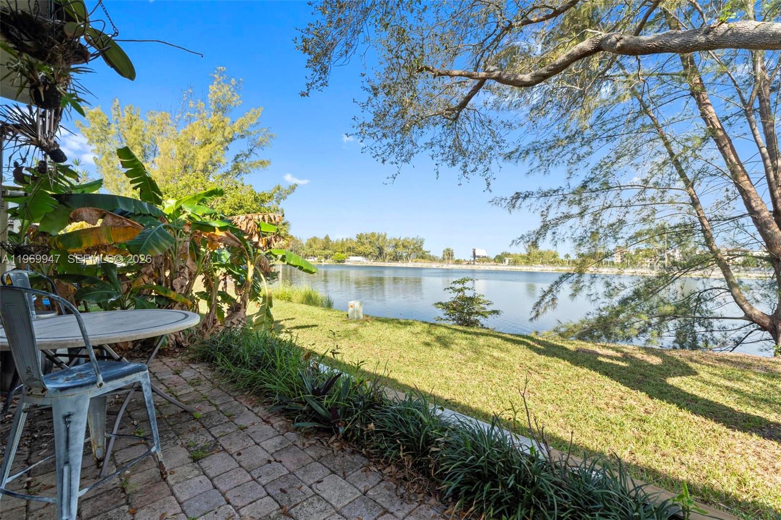 3370 Beau Rivage Drive, Unit B8 Pompano Beach, FL 33064 - Photo 5 of 33 a view of a swimming pool with a yard and sitting area