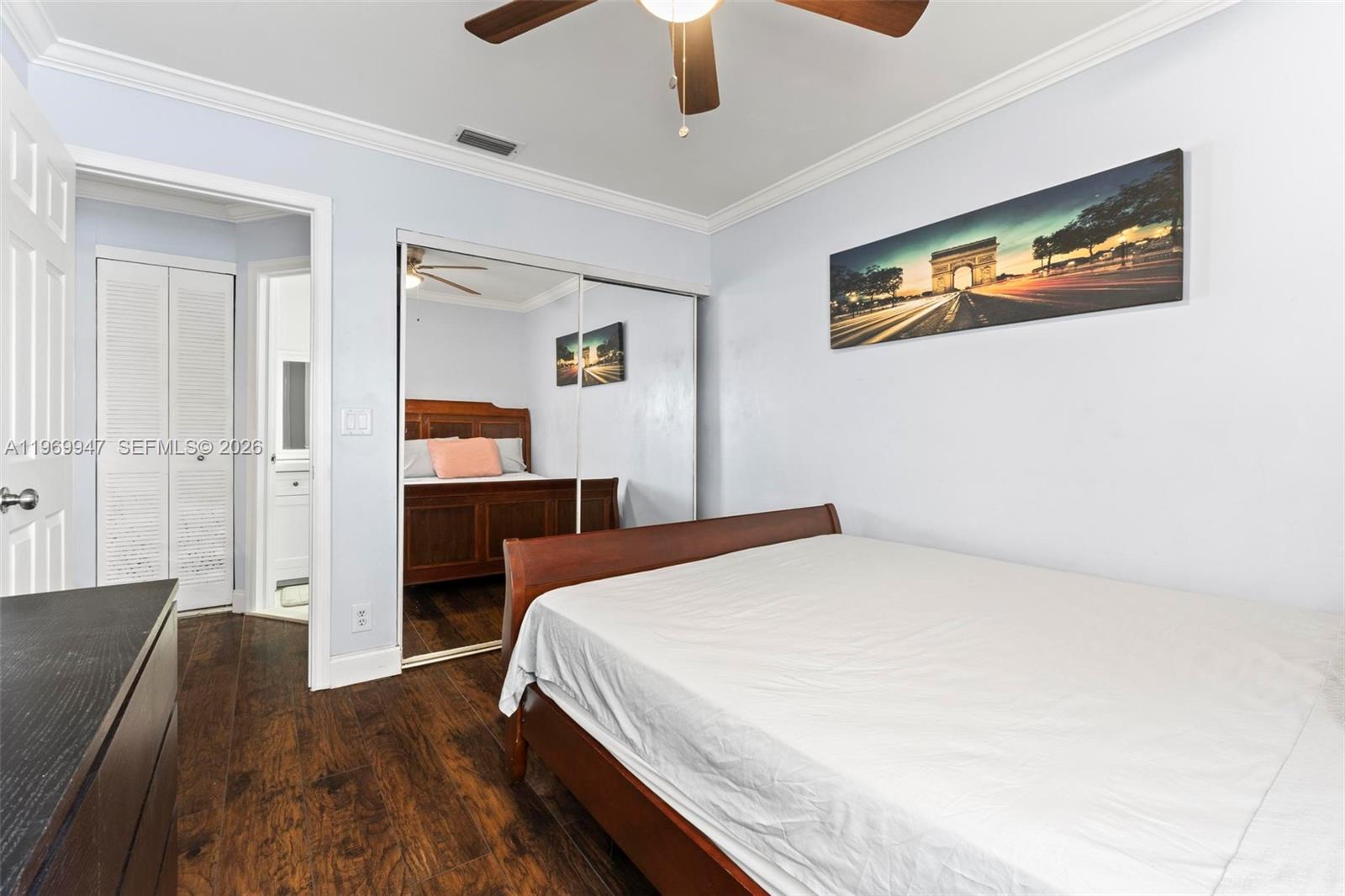 3370 Beau Rivage Drive, Unit B8 Pompano Beach, FL 33064 - Photo 8 of 33 a bedroom with a bed and a chandelier