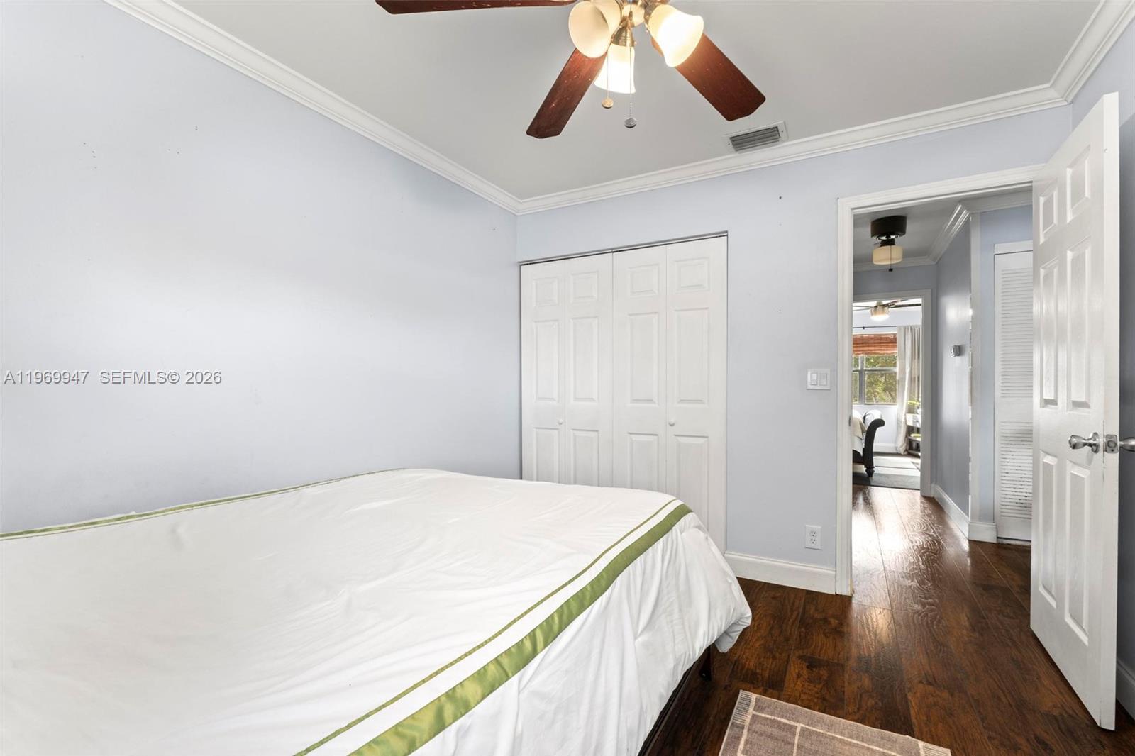 3370 Beau Rivage Drive, Unit B8 Pompano Beach, FL 33064 - Photo 10 of 33 a bedroom with a bed and wooden floor