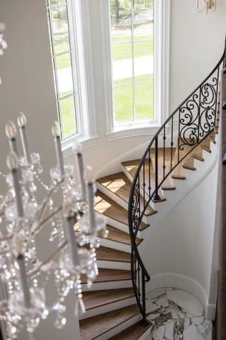 a kitchen with stainless steel appliances granite countertop a sink a stove and a wooden floors
