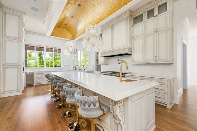 a view of a hallway with wooden floor and a living room