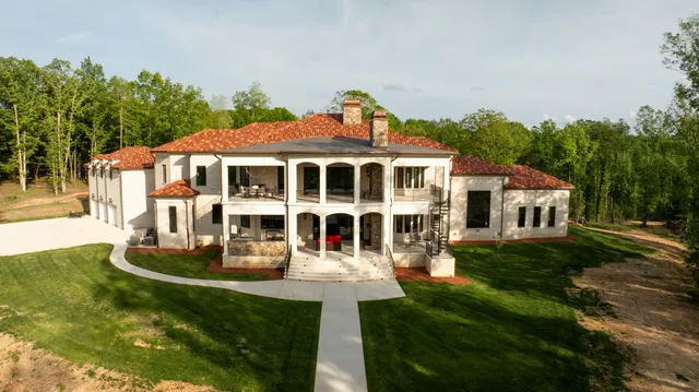 a front view of a house with a yard table and chairs