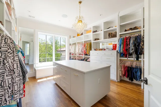 a kitchen with a stove a sink and a wooden cabinets