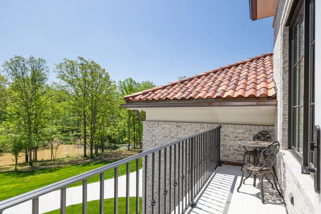 a large white kitchen with a large window a sink and a dishwasher