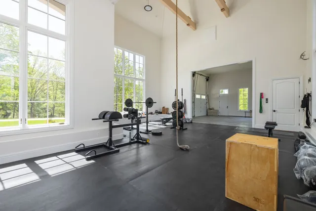 a bedroom with a bed window and a table