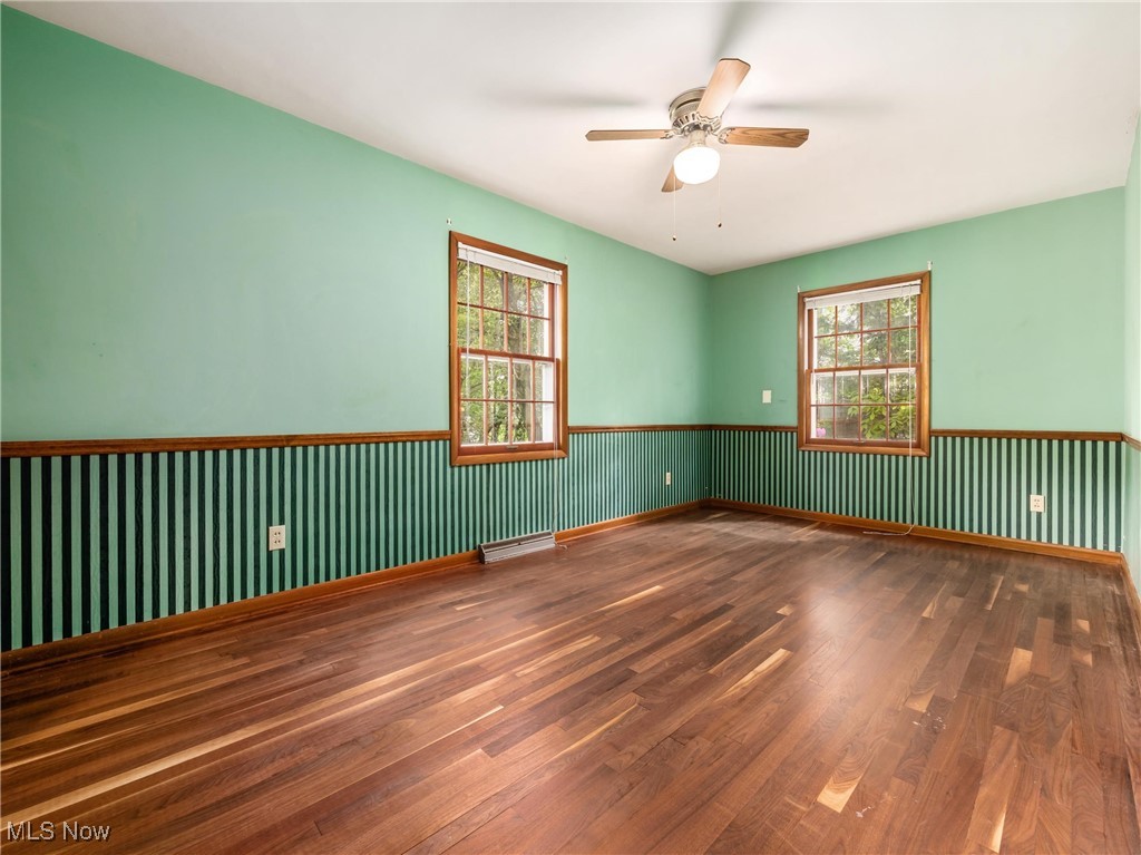 975 Richey Road Zanesville, OH 43701 - Photo 20 of 27 Spare room featuring wood finished floors, ceiling fan, and wainscoting