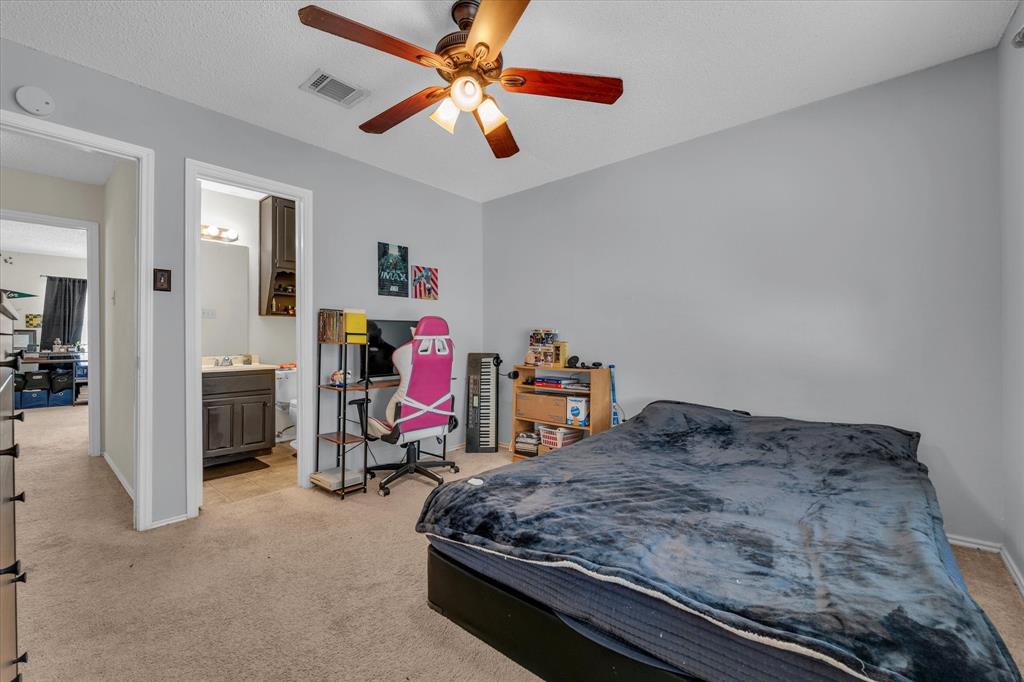 1349 South 11th Street Waco, TX 76706 - Photo 11 of 17 a bedroom with bed and a chandelier