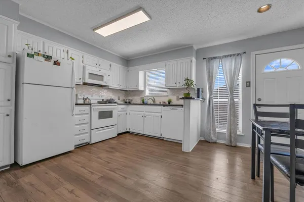 a kitchen with stainless steel appliances a refrigerator sink and cabinets