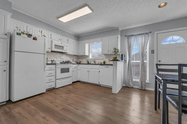 a kitchen with stainless steel appliances a refrigerator sink and cabinets