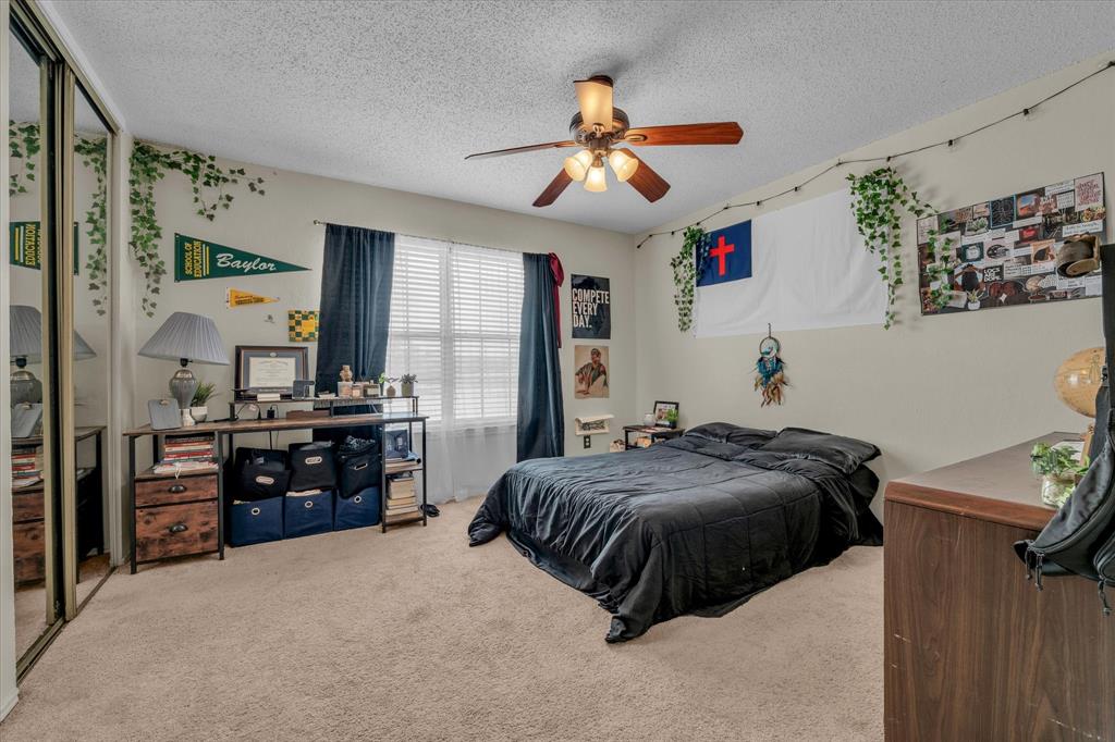 1349 South 11th Street Waco, TX 76706 - Photo 9 of 17 a bedroom with a bed and dresser with mirror