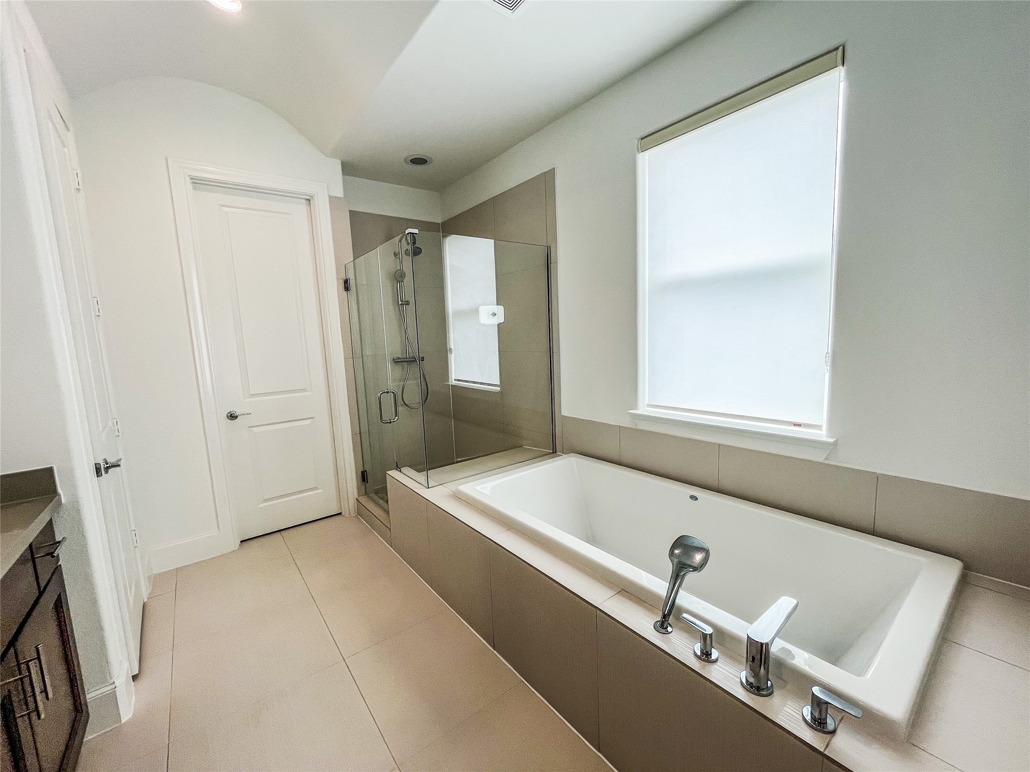 2024 Waterloo Station Road Houston, TX 77045 - Photo 9 of 14 Oversized glass enclosed stand up shower (with a seat) & tub to relax in after a long day at work.