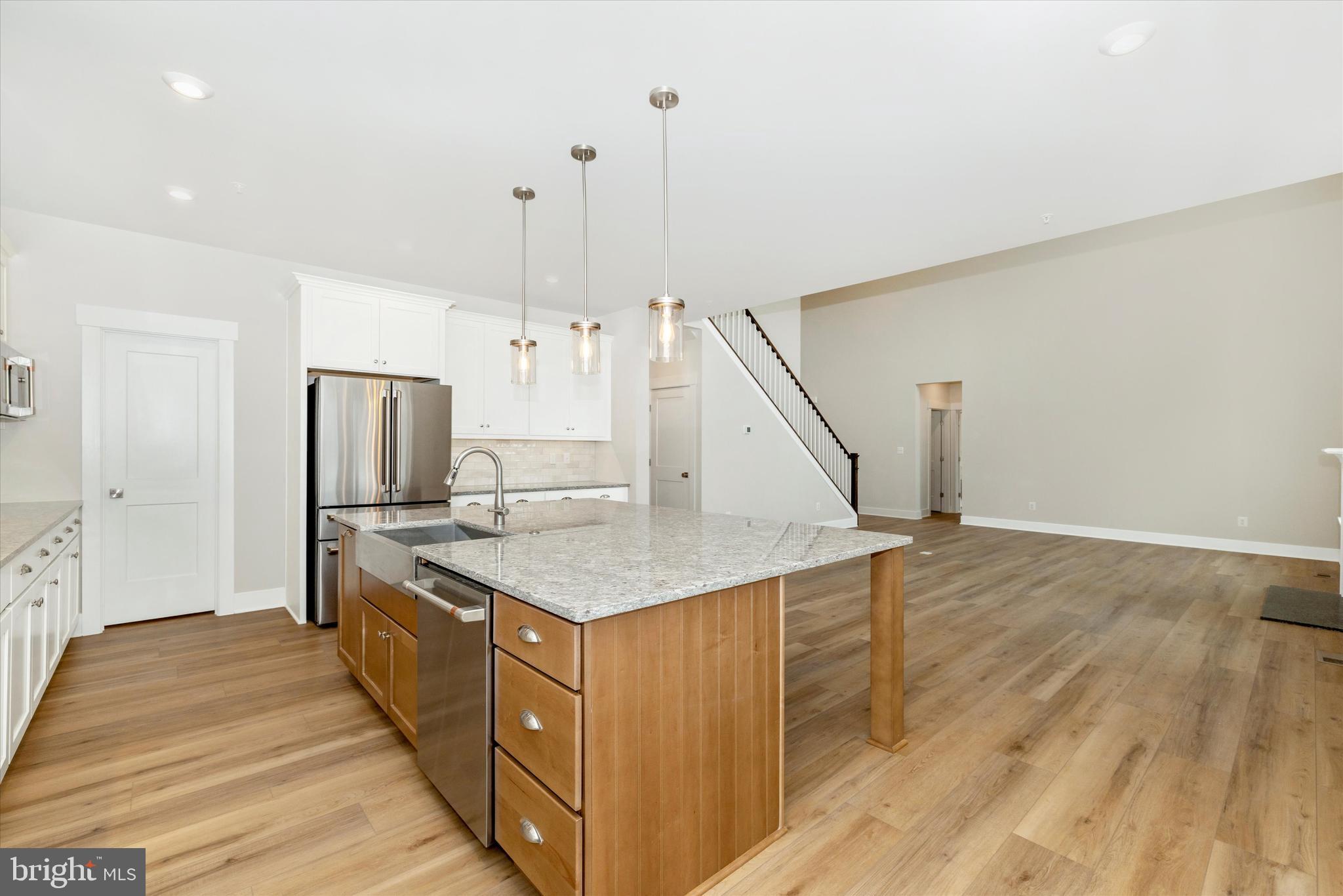 10230 Daysville Road Walkersville, MD 21793 - Photo 17 of 43 a kitchen with stainless steel appliances kitchen island a hardwood floor and a sink