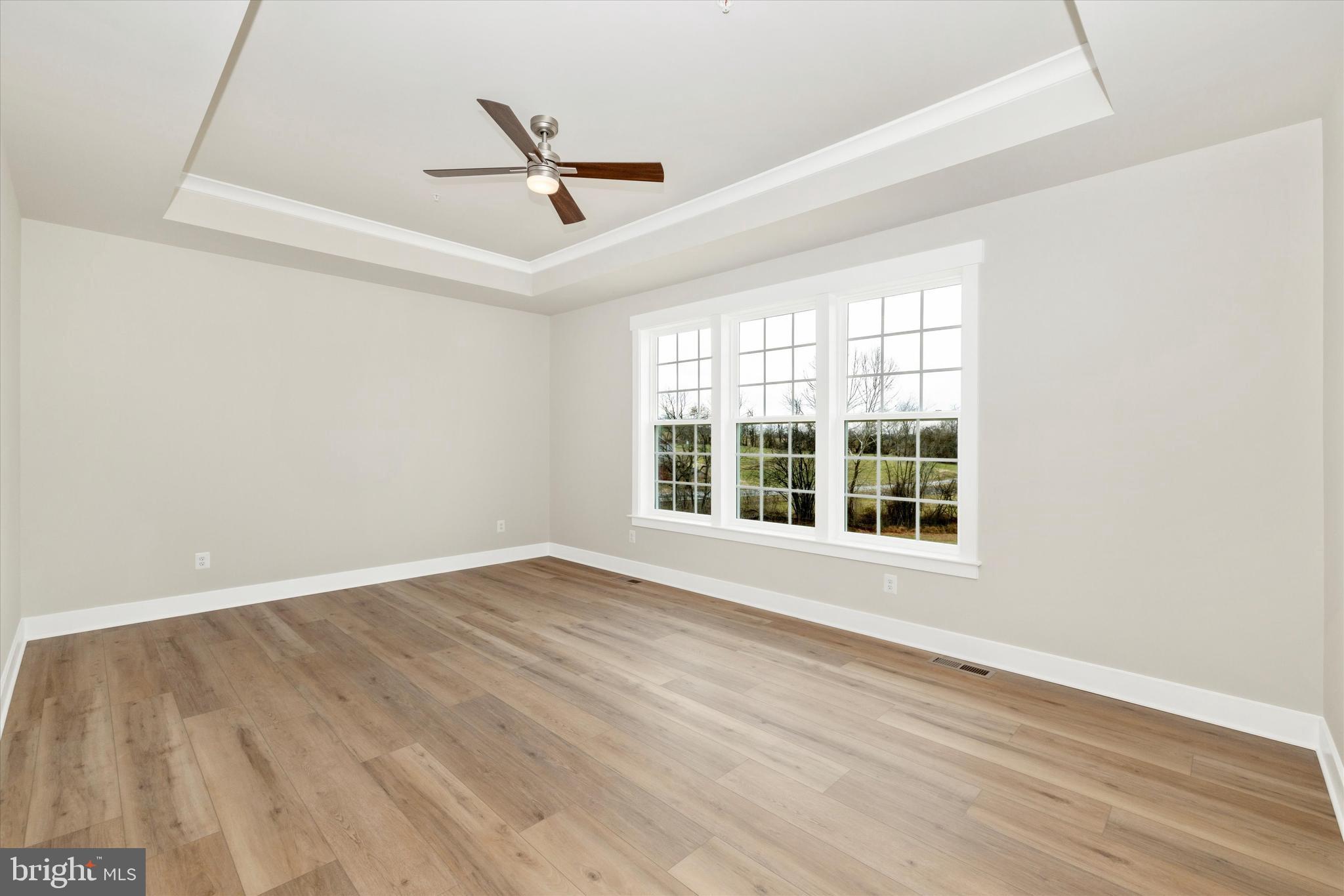 10230 Daysville Road Walkersville, MD 21793 - Photo 20 of 43 an empty room with wooden floor fan and windows