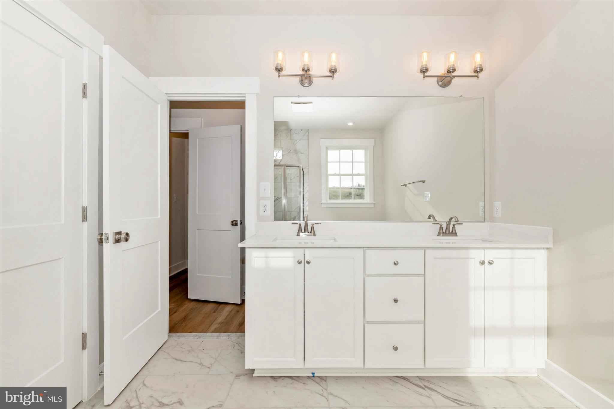10230 Daysville Road Walkersville, MD 21793 - Photo 26 of 43 a spacious bathroom with double sink and a mirror