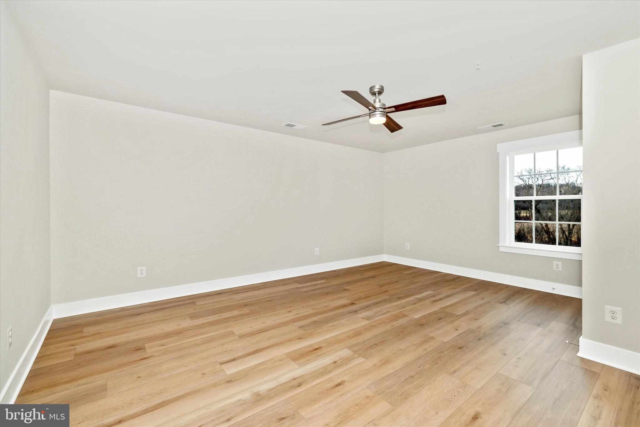 10230 Daysville Road Walkersville, MD 21793 - Photo 27 of 43 an empty room with wooden floor and windows
