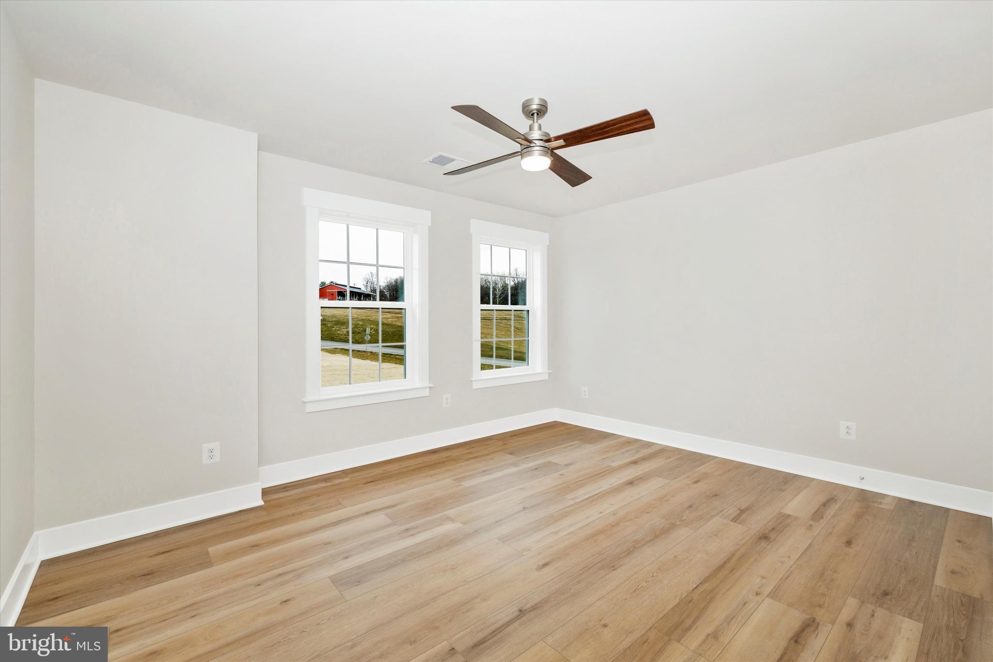 10230 Daysville Road Walkersville, MD 21793 - Photo 29 of 43 a view of an empty room with wooden floor and a window