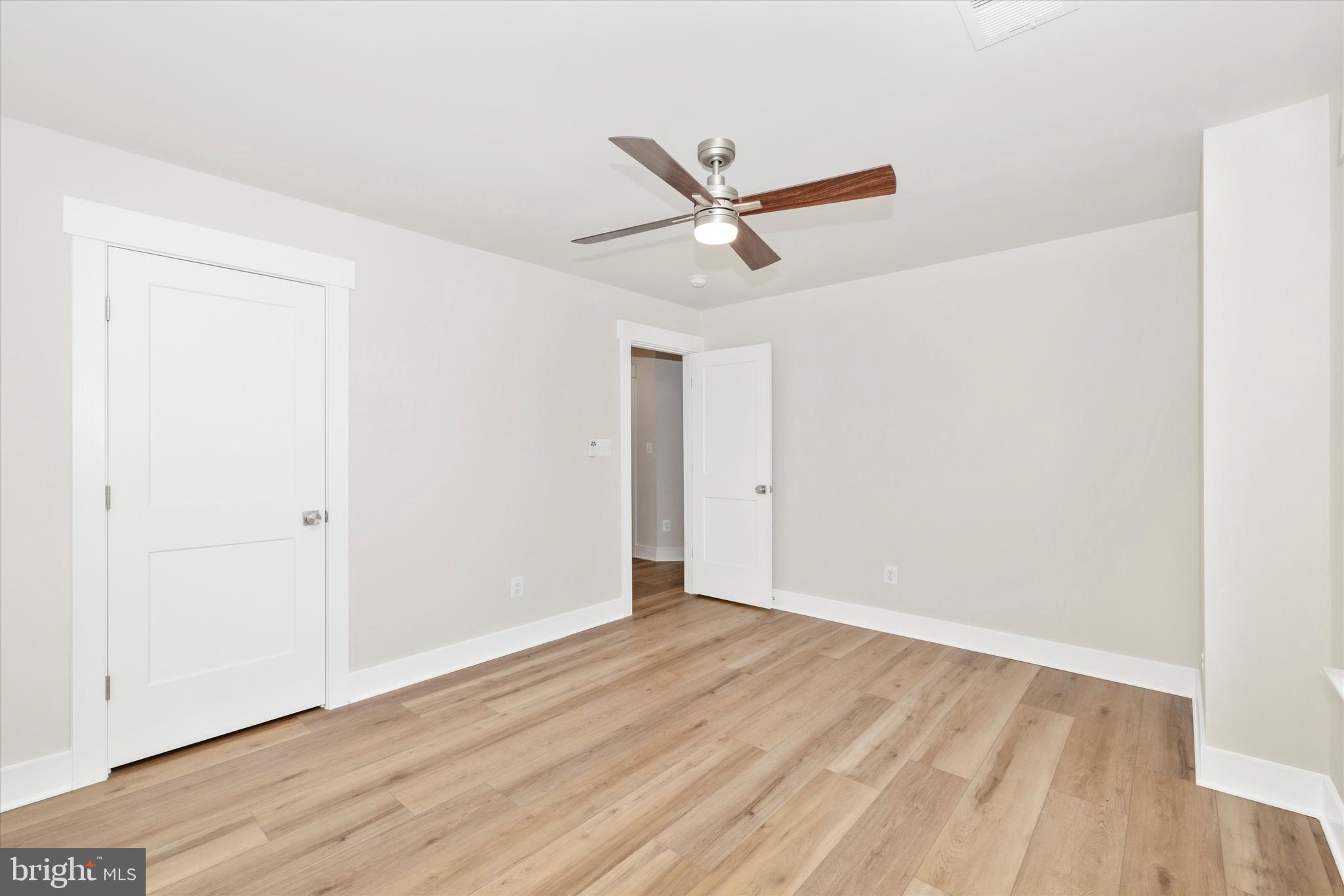 10230 Daysville Road Walkersville, MD 21793 - Photo 30 of 43 an empty room with wooden floor and a ceiling fan