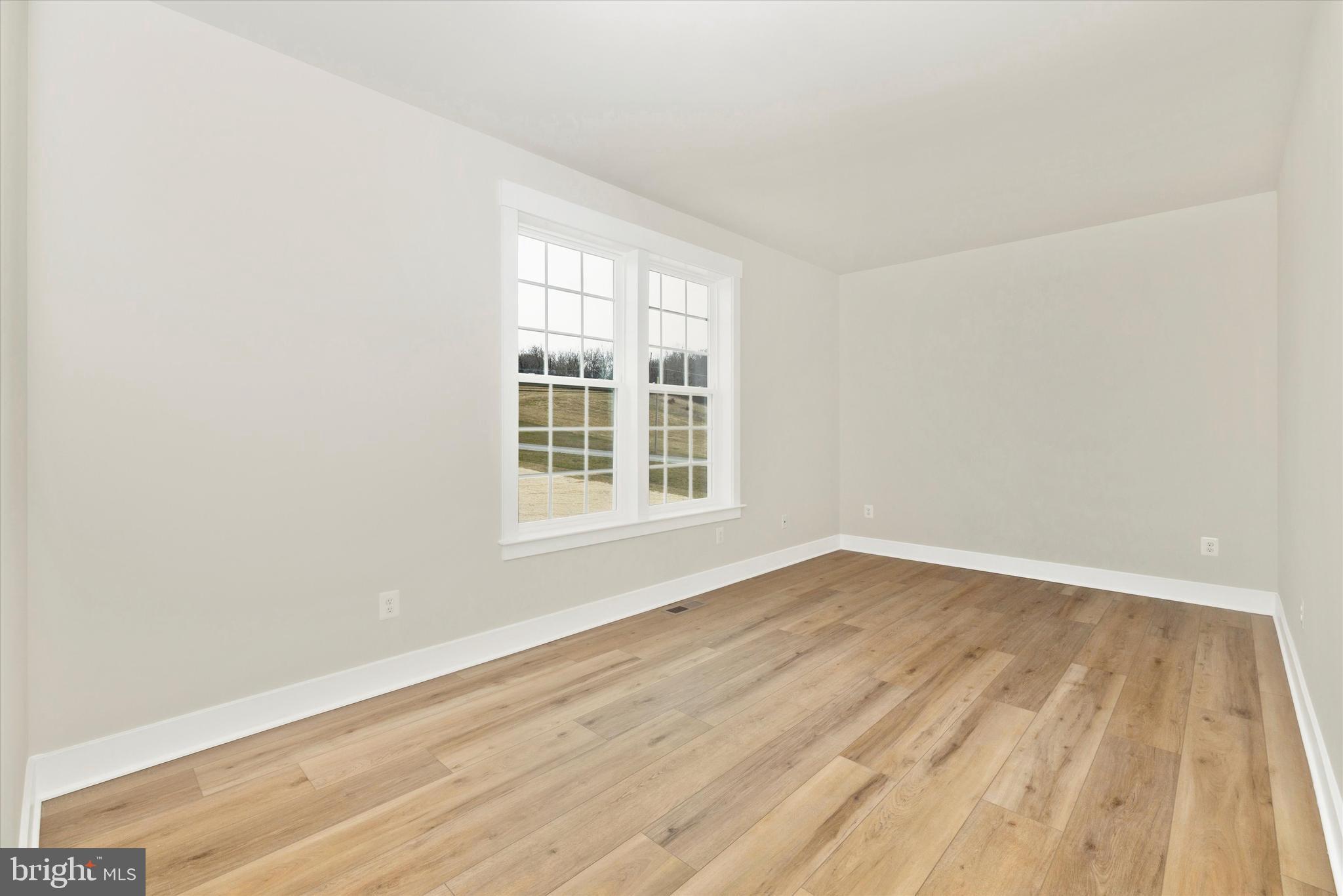 10230 Daysville Road Walkersville, MD 21793 - Photo 5 of 43 an empty room with wooden floor and windows