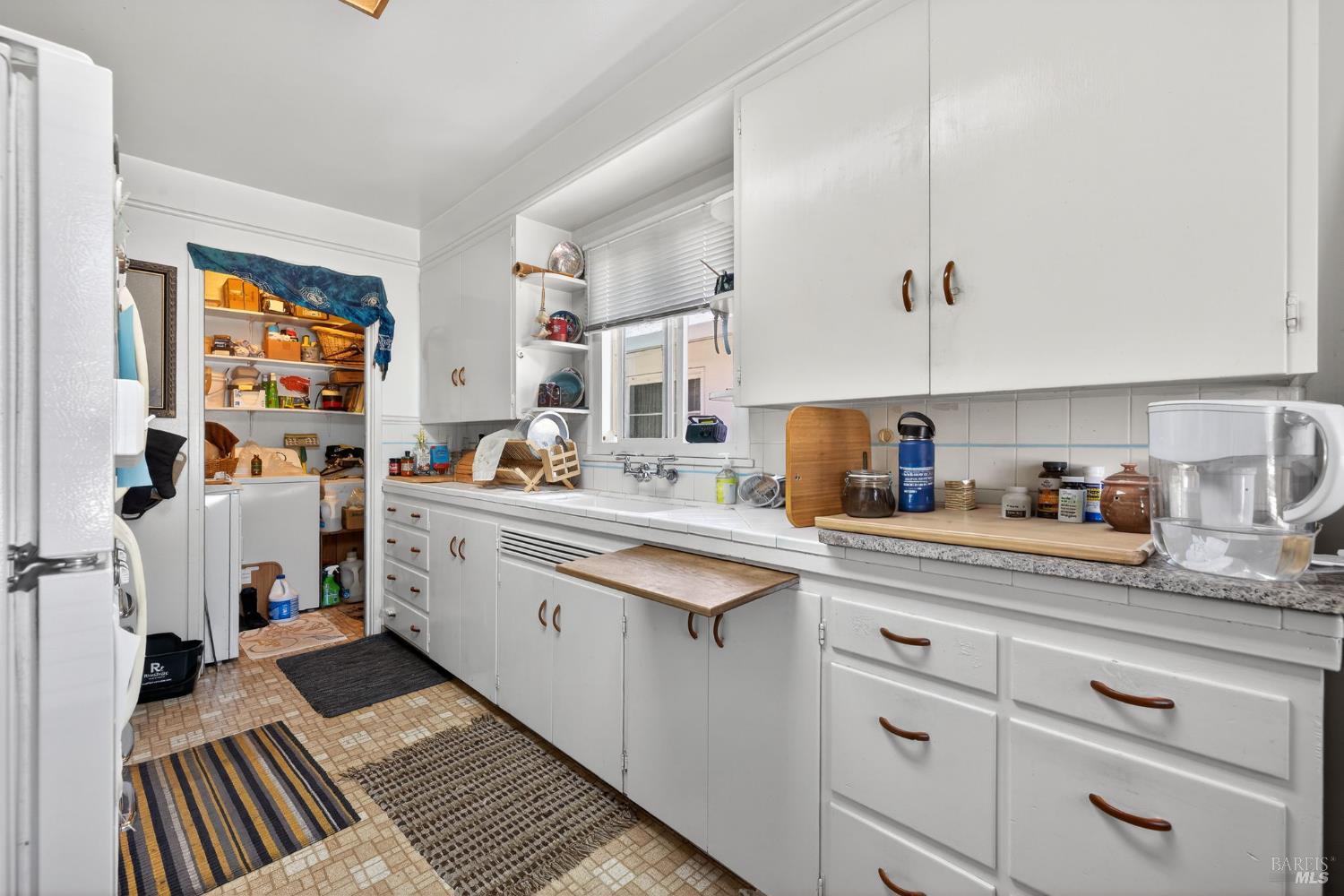 1204 14th Street Santa Rosa, CA 95404 - Photo 19 of 26 1202 14Th Street, Kitchen includes the refrigerator and beautiful Occidental gas stove. Laundry room at rear of photo includes the washer/dryer in this unit.