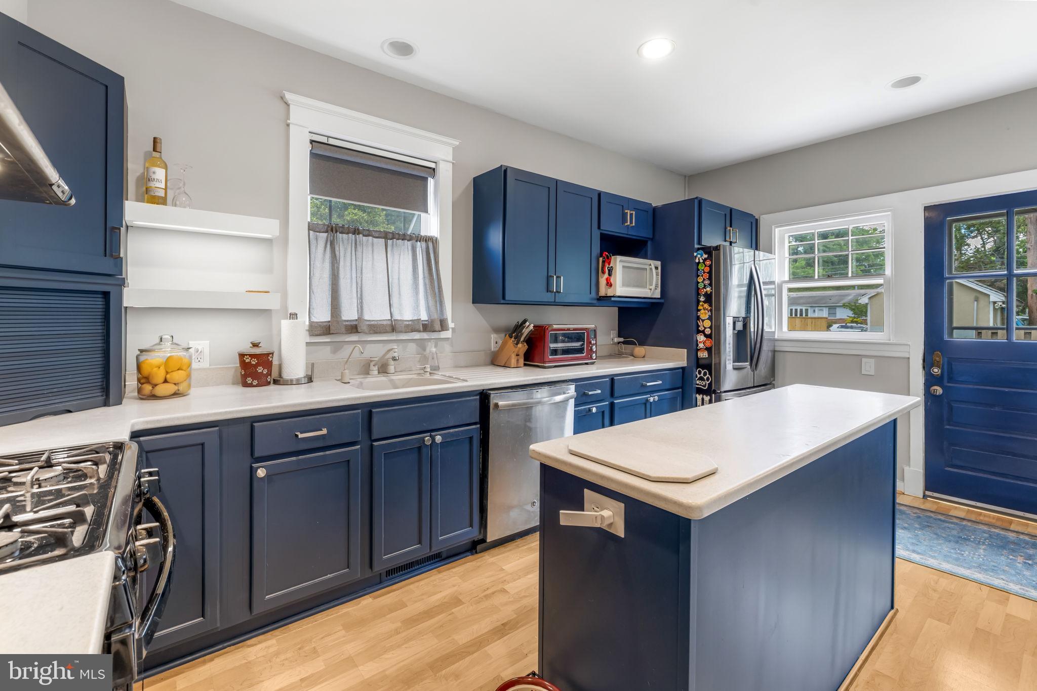 765 Dividing Road Severna Park, MD 21146 - Photo 7 of 17 a kitchen with a sink a stove a refrigerator cabinets and a window