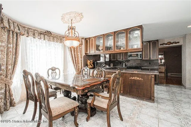 a dining room with furniture and window