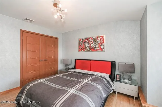 a bedroom with a bed and a dresser