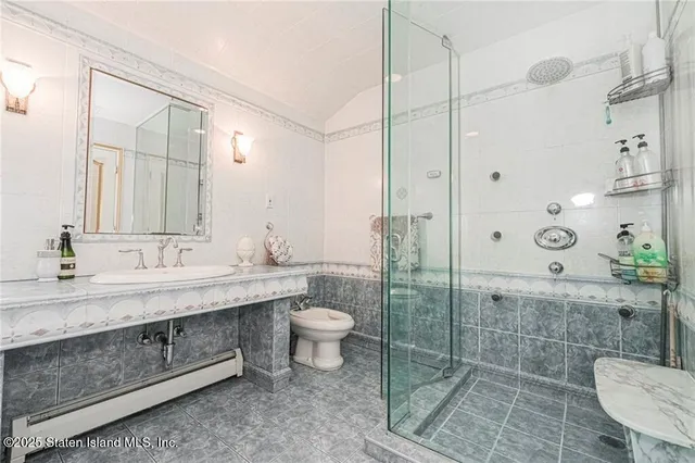 a bathroom with a double vanity sink toilet and shower