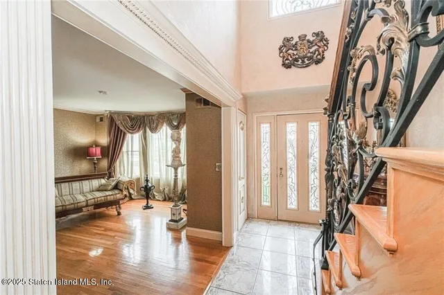 a view of a hallway with wooden floor and a living room